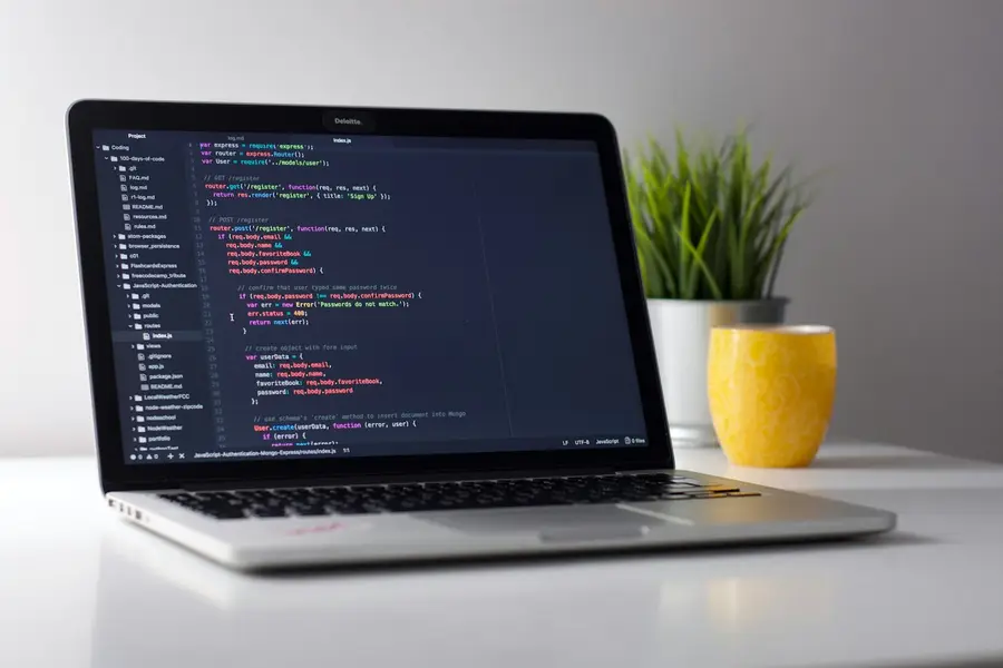 Laptop showing code on a clean desk