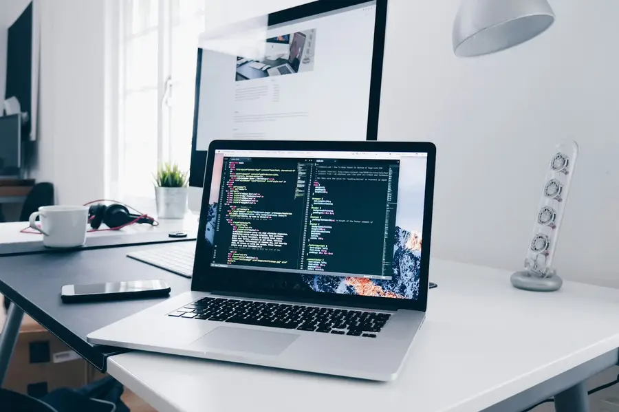 Tidy desk with a laptop running code
